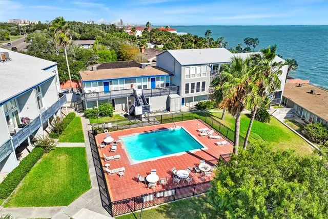 an aerial view of a house with swimming pool garden and patio