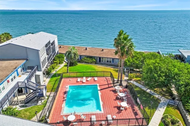 a view of a tennis court with a large pool