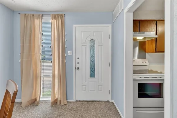 a view of a kitchen with an entryway and a fireplace