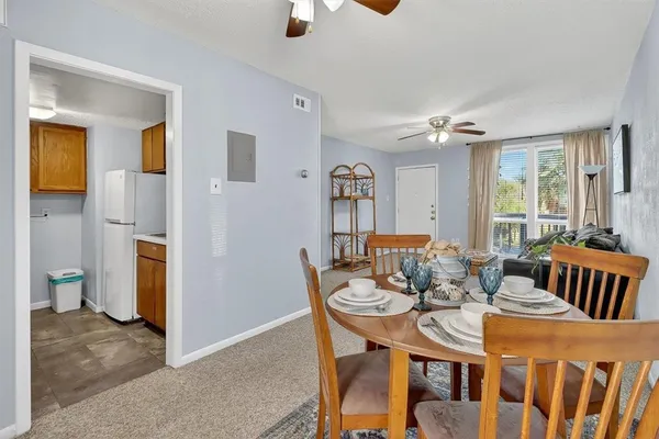 a view of a dining room with furniture and window