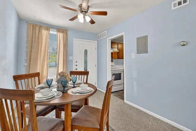 a view of a dining room with furniture and window