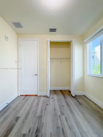 a view of hallway with wooden floor