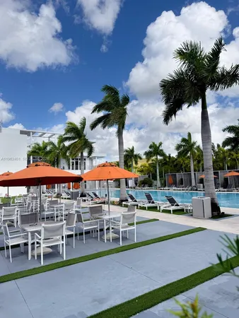 a living room with a table chairs and a wooden floor