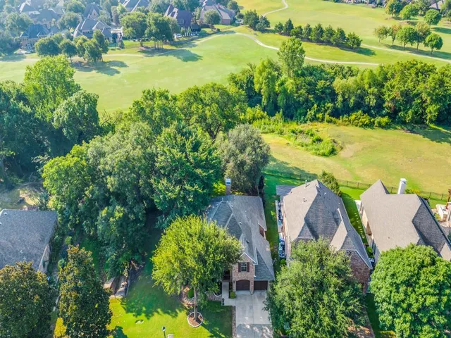 an aerial view of a residential houses with outdoor space and swimming pool