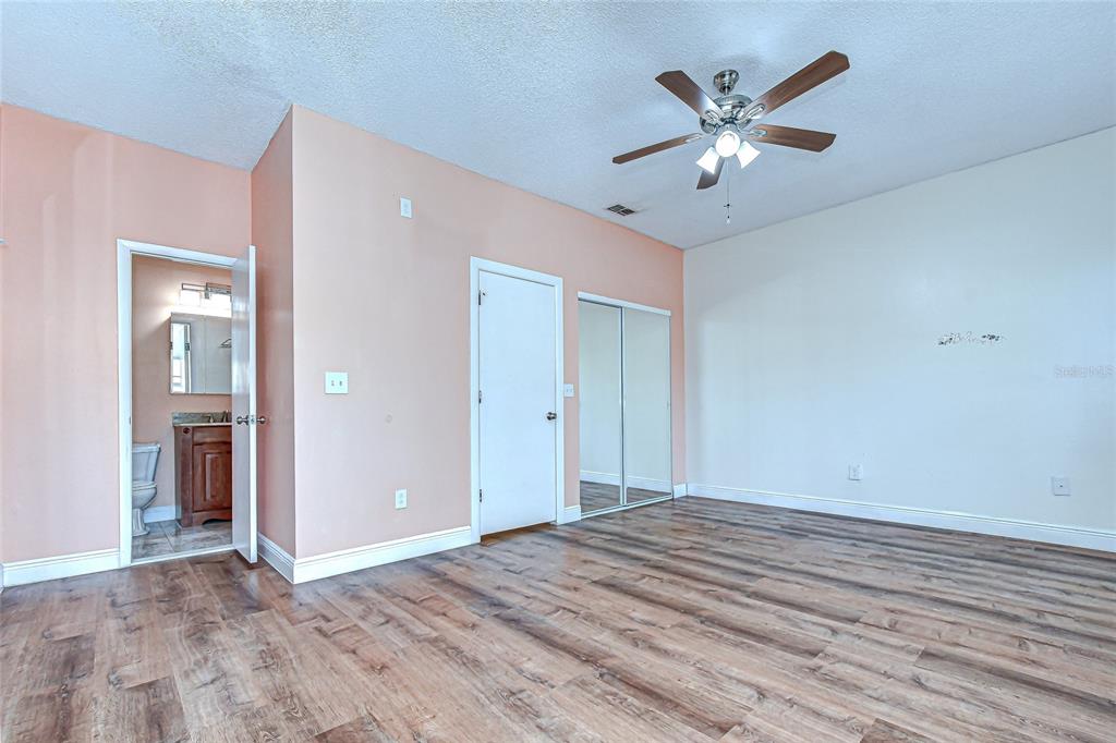602 Fieldcrest Drive Brandon, FL 33511 - Photo 13 of 23 wooden floor in an empty room with a ceiling fan
