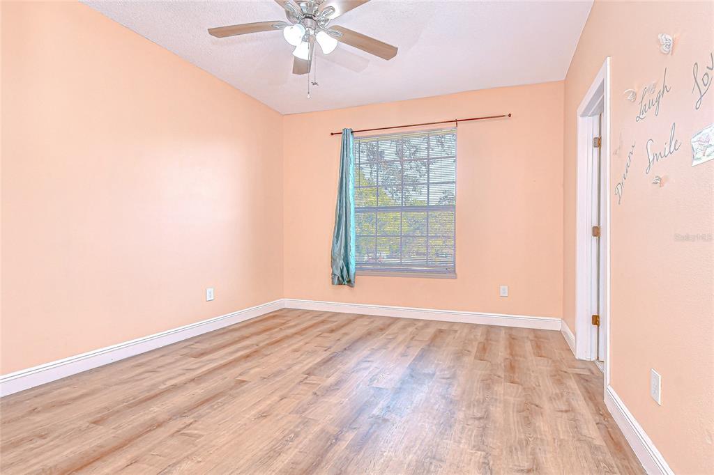 602 Fieldcrest Drive Brandon, FL 33511 - Photo 15 of 23 an empty room with wooden floor chandelier fan and windows