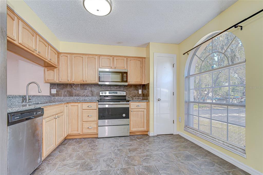 602 Fieldcrest Drive Brandon, FL 33511 - Photo 5 of 23 a kitchen with stainless steel appliances granite countertop a stove and a sink