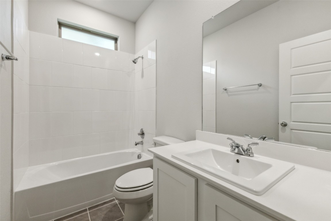 153 Tolo Drive Elgin, TX 78621 - Photo 17 of 25 a bathroom with a sink a toilet and shower