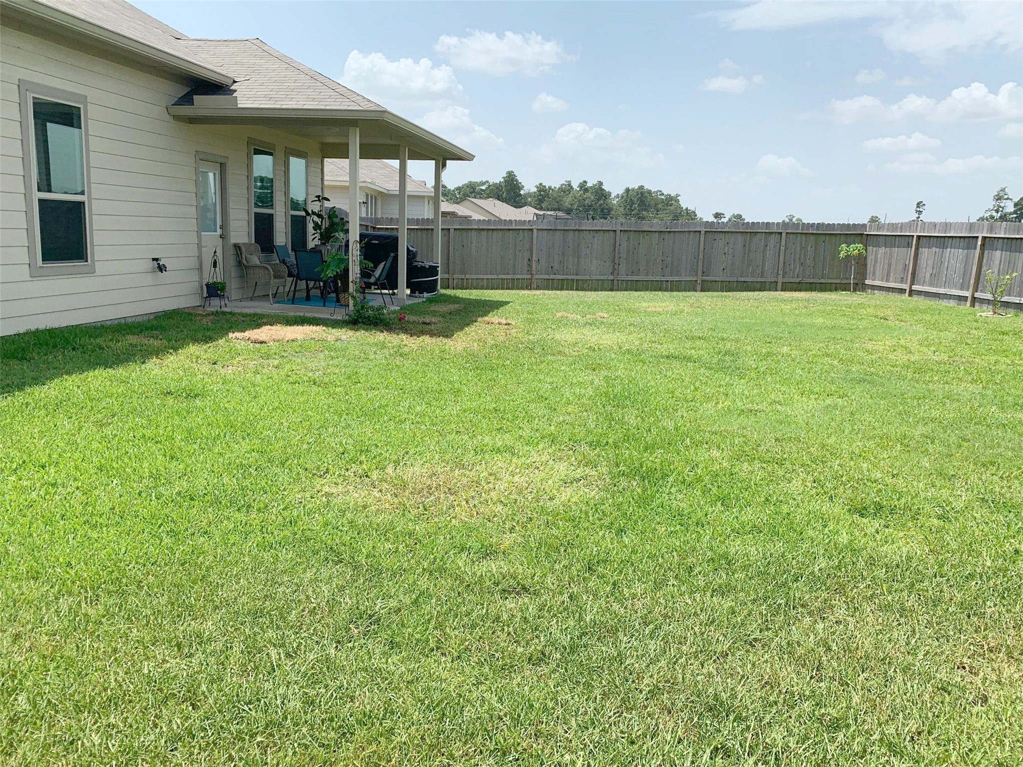 9931 Swindale Ridge Lane Houston, TX 77044 - Photo 27 of 29 a view of a swimming pool with a patio and a yard