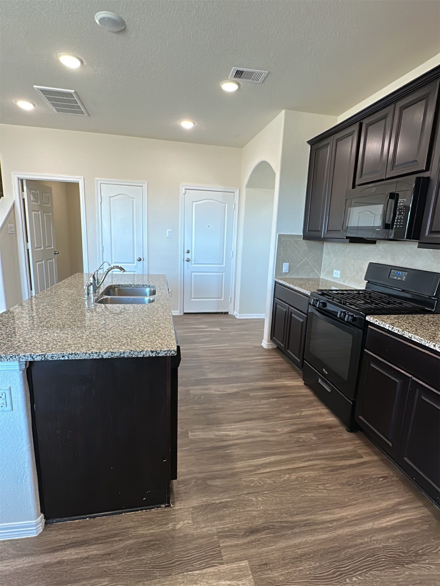 9931 Swindale Ridge Lane Houston, TX 77044 - Photo 8 of 29 a kitchen with granite countertop stainless steel appliances and wooden cabinets