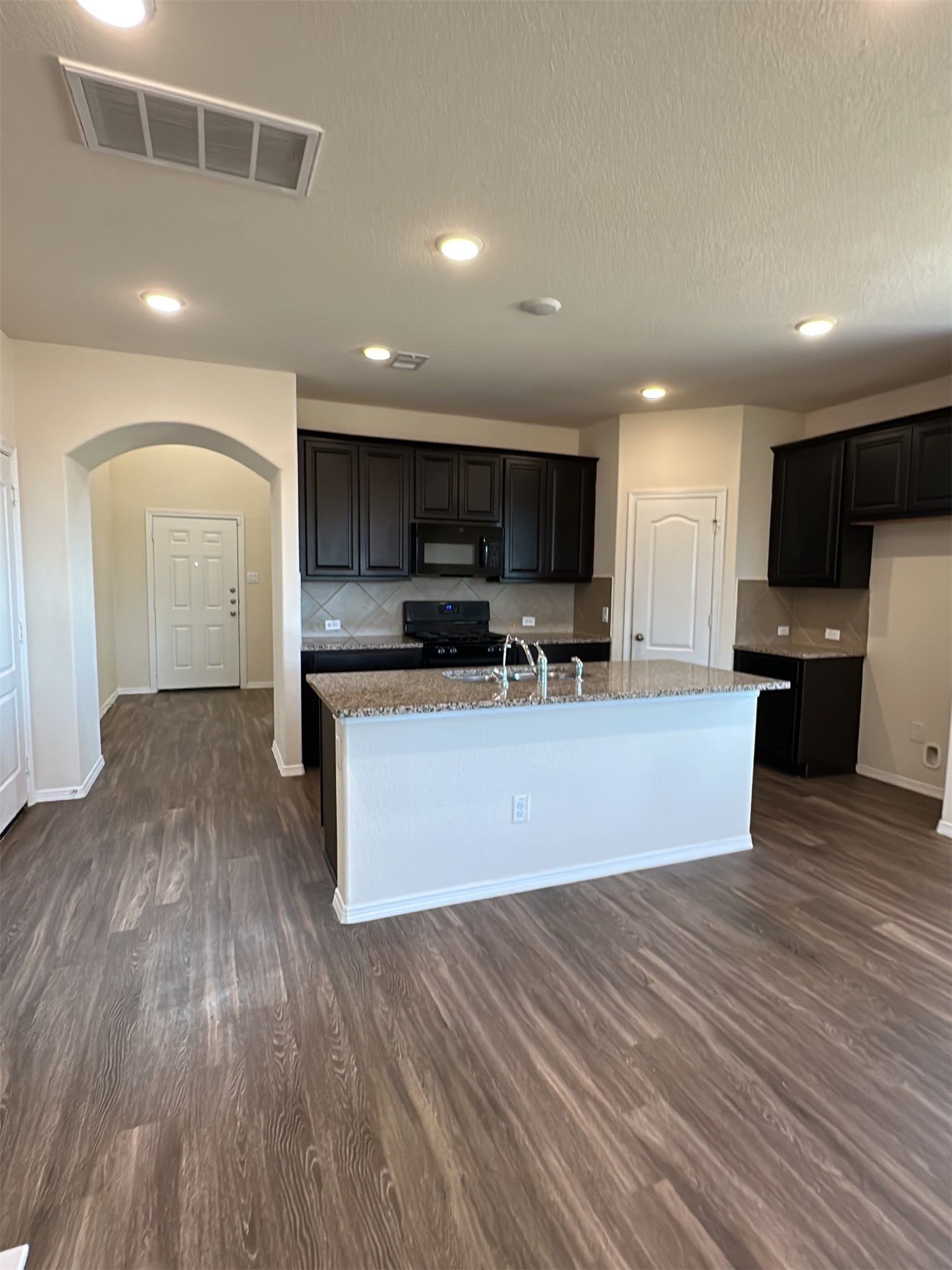 9931 Swindale Ridge Lane Houston, TX 77044 - Photo 9 of 29 a view of kitchen with wooden floor and electronic appliances