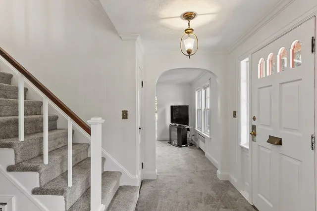 a view of a livingroom with wooden floor and stairs