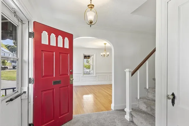 a view of a hallway with wooden floor and entryway