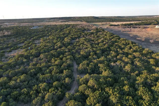 an aerial view of ocean with residential houses with outdoor space