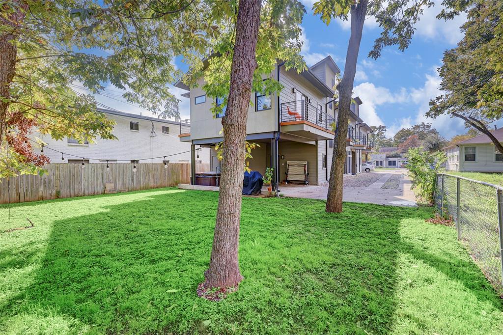 602 West N Loop Boulevard, Unit B Austin, TX 78751 - Photo 3 of 21 Mature trees shade a spacious green lawn bordering the multi-level modern structure.