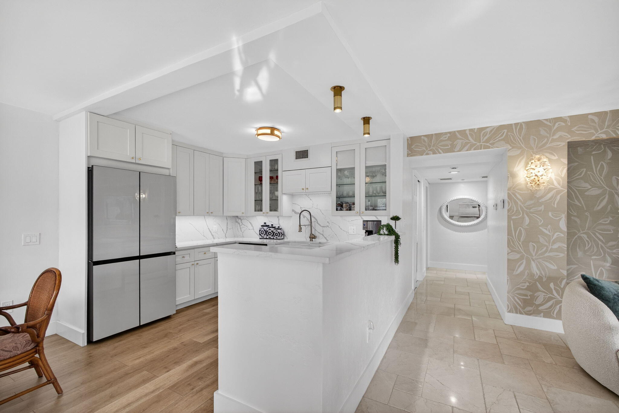129 South Golfview Road, Unit 6 Lake Worth Beach, FL 33460 - Photo 6 of 51 a kitchen with stainless steel appliances granite countertop a refrigerator a sink a stove and white cabinets with wooden floor