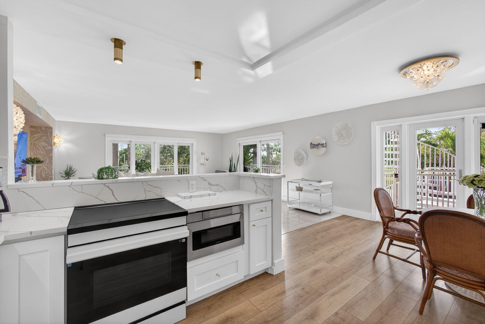 129 South Golfview Road, Unit 6 Lake Worth Beach, FL 33460 - Photo 7 of 51 a kitchen with stove and chairs
