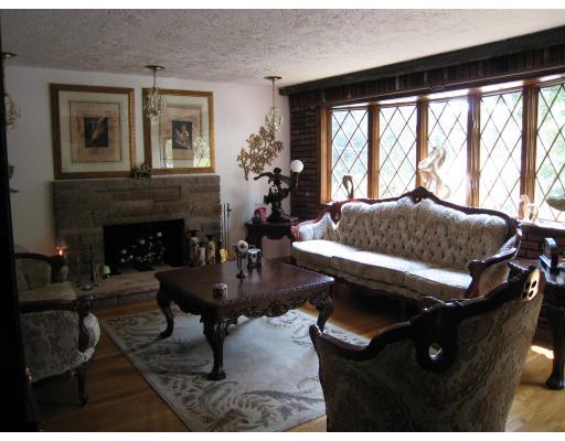 135 Winchester Road Arlington, MA 02474 - Photo 6 of 12 a living room with furniture and a fireplace