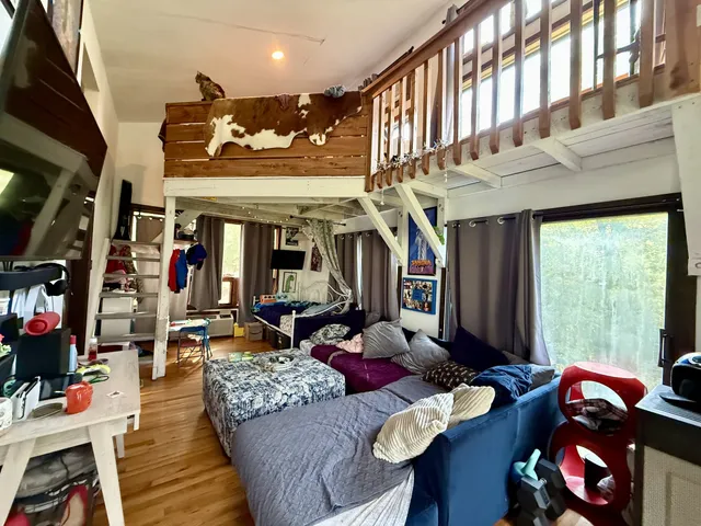 a view of a kitchen with fridge and workspace