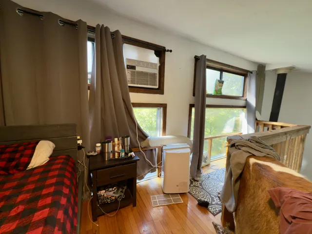 a bed sitting in a bedroom next to a window