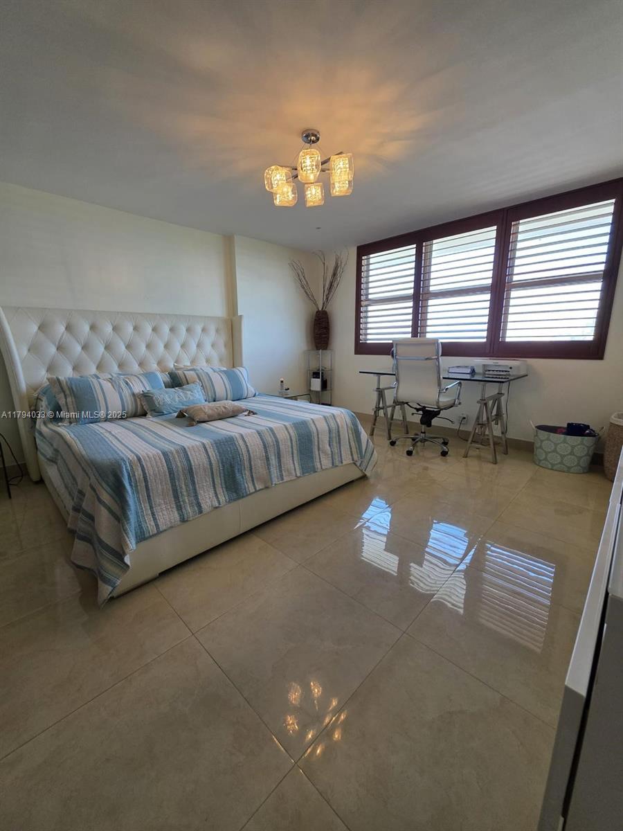 9225 Collins Avenue, Unit 1409 Surfside, FL 33154 - Photo 22 of 41 a living room with furniture and a large window