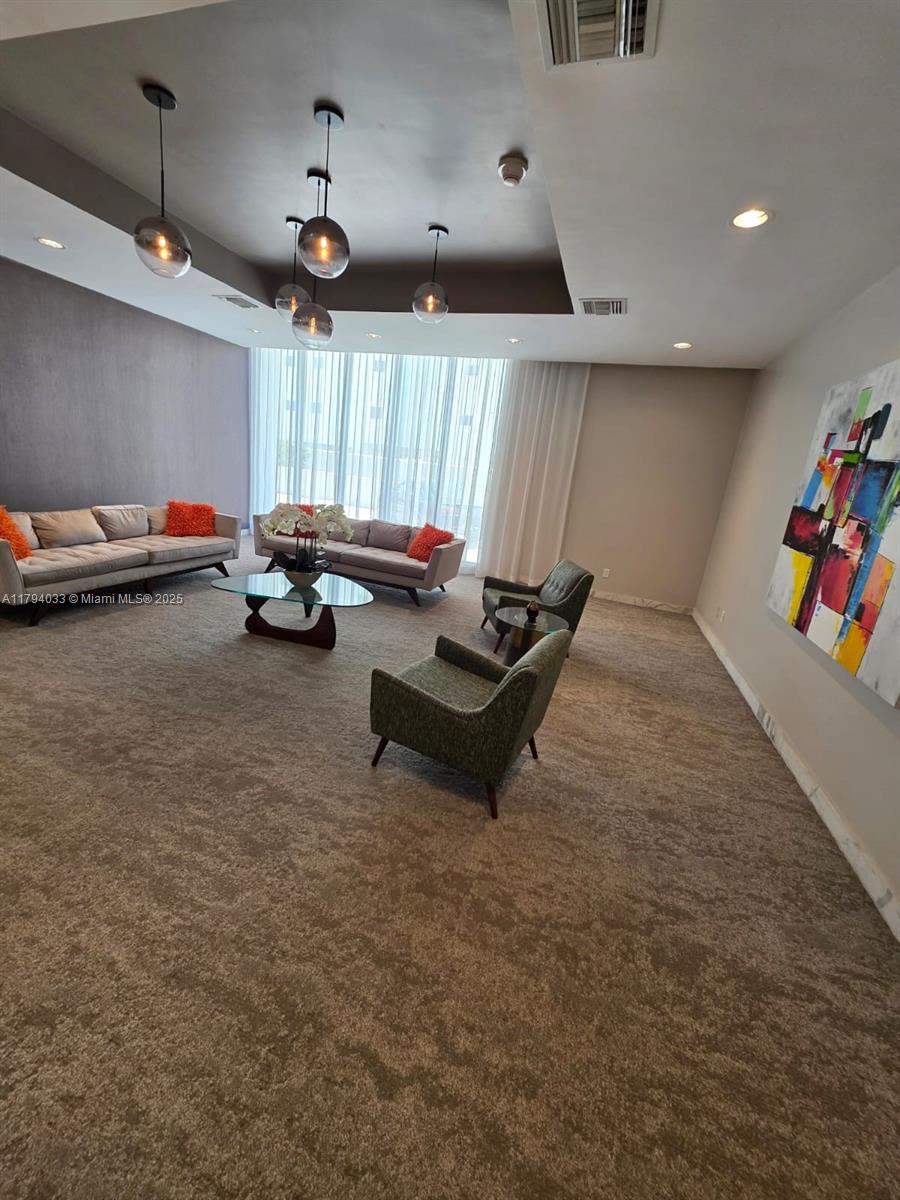 9225 Collins Avenue, Unit 1409 Surfside, FL 33154 - Photo 33 of 41 a living room with furniture and a flat screen tv