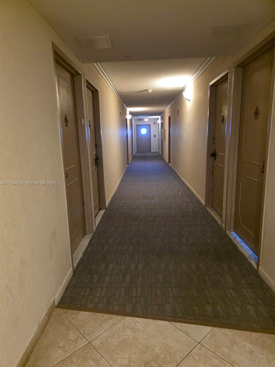 9225 Collins Avenue, Unit 1409 Surfside, FL 33154 - Photo 38 of 41 a view of a hallway