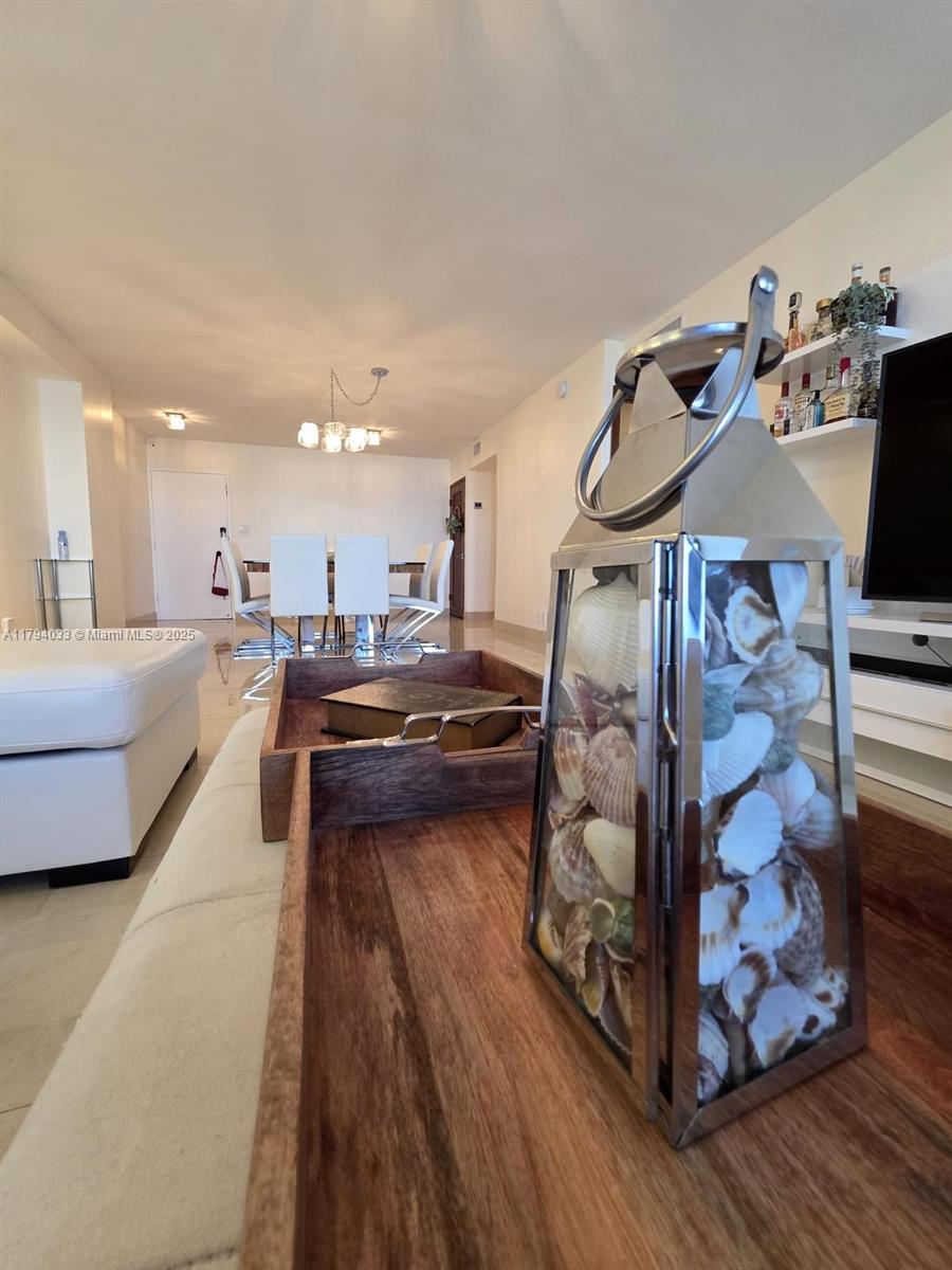 9225 Collins Avenue, Unit 1409 Surfside, FL 33154 - Photo 5 of 41 a living room with furniture and wooden floor