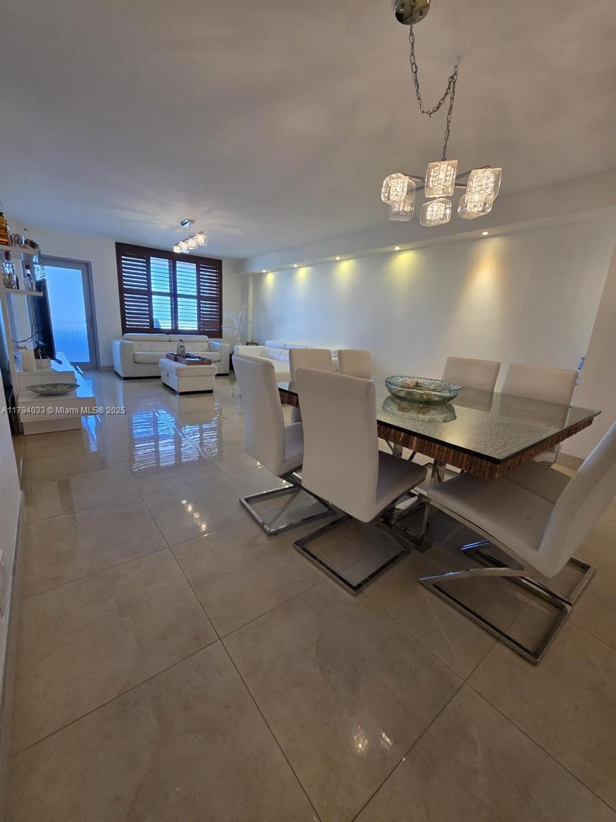 9225 Collins Avenue, Unit 1409 Surfside, FL 33154 - Photo 8 of 41 a view of a dining room with furniture