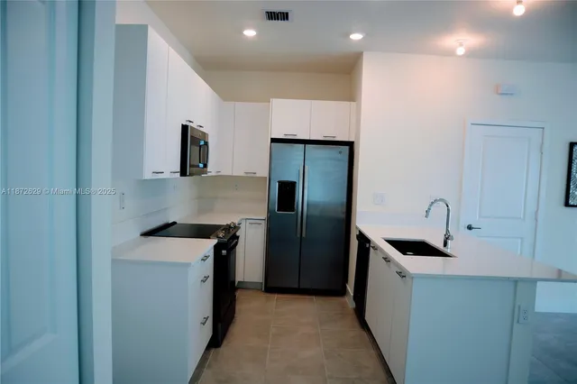 a kitchen with a sink and refrigerator