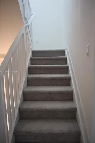 a view of staircase with white walls