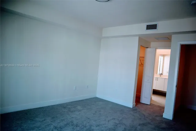 an empty room with closet area