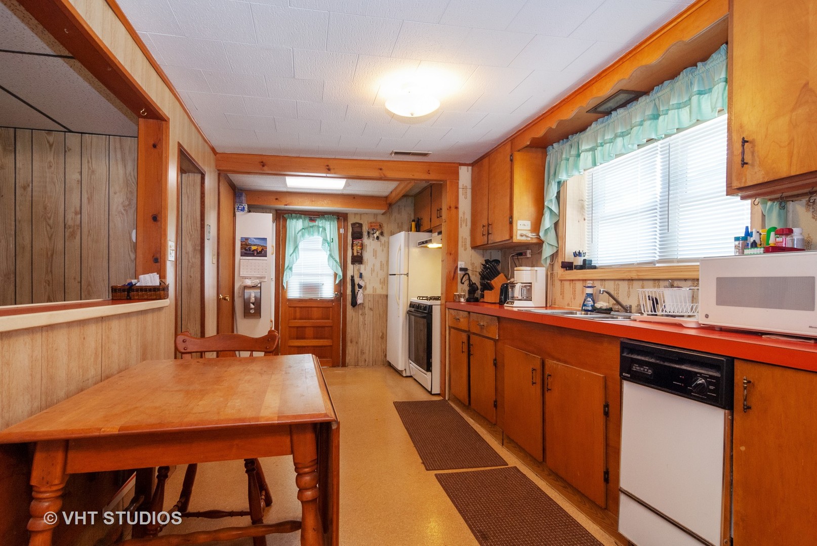 4740 Mill Road Oswego, IL 60543 - Photo 3 of 13 a kitchen with a sink and wooden cabinets