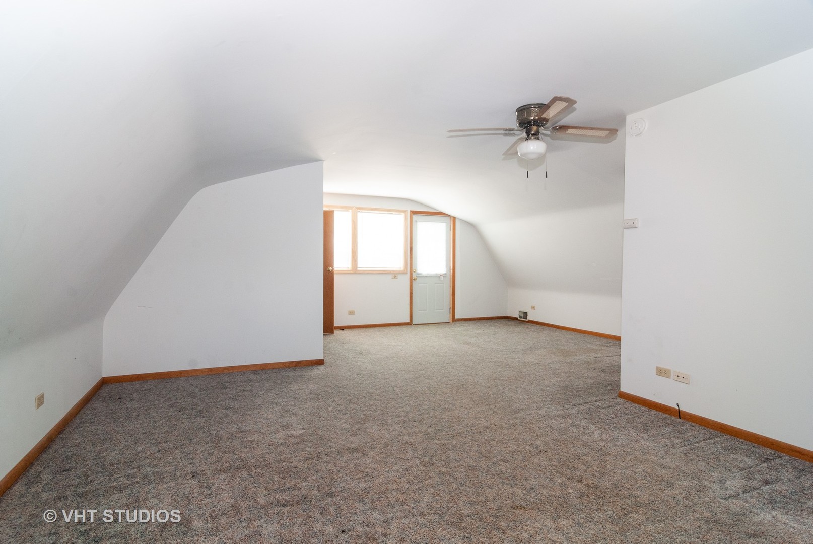 4740 Mill Road Oswego, IL 60543 - Photo 8 of 13 an empty room with a chandelier fan and windows
