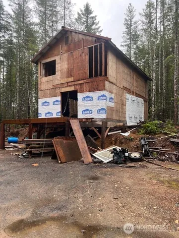 a backyard of a house with cars parked