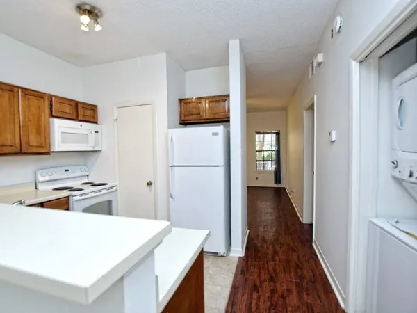 a kitchen with a refrigerator and a stove top oven