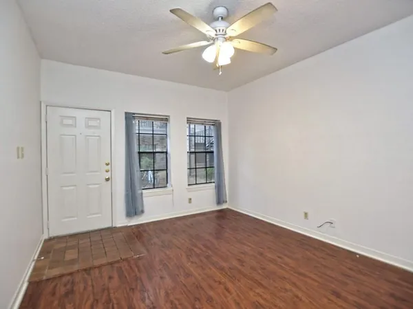 wooden floor in an empty room with a window