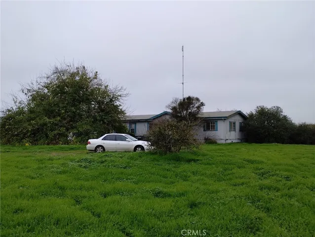 a view of a garden with a table and chairs