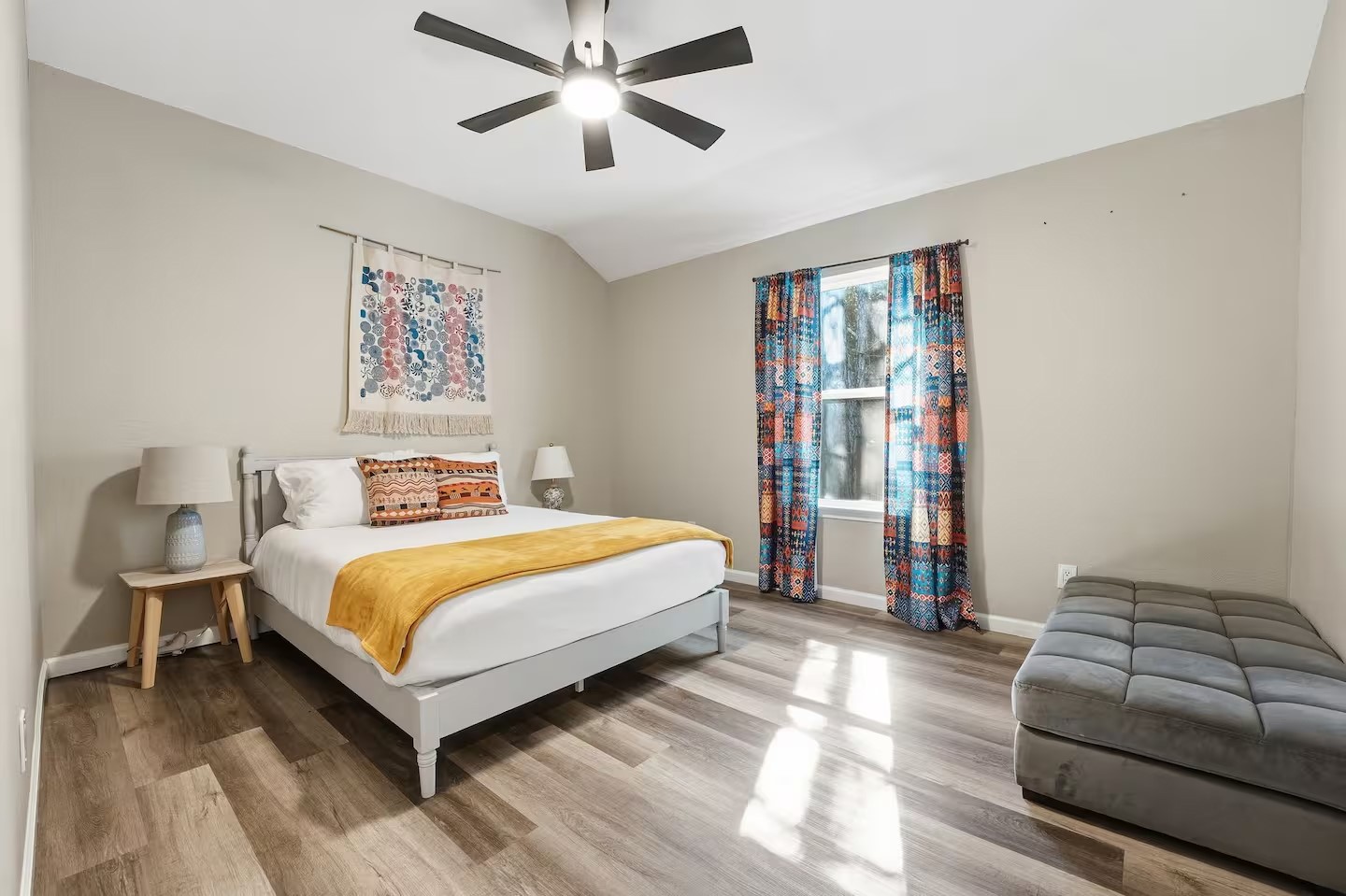 201 Winfield Thicket Road Bastrop, TX 78602 - Photo 19 of 36 a bedroom with a large bed and a chandelier