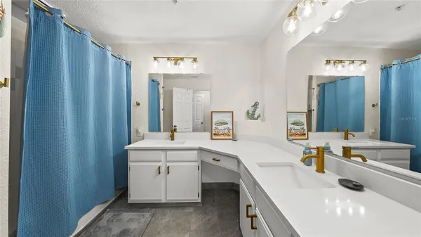 a bedroom with a bed a desk and chair