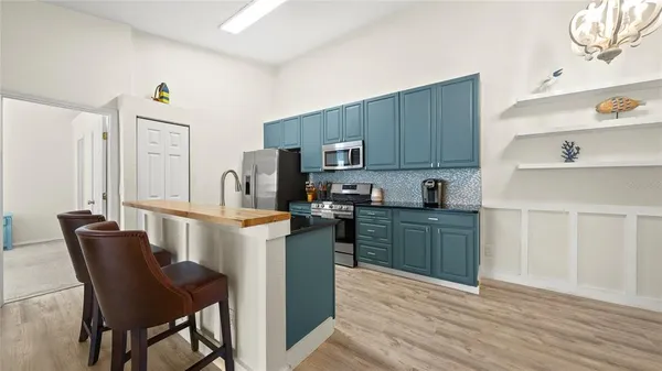 a kitchen with stainless steel appliances a refrigerator stove microwave and cabinets