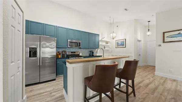 a living room with furniture a fireplace and potted plants