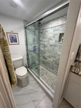 a bedroom with a bed and a lamp on table