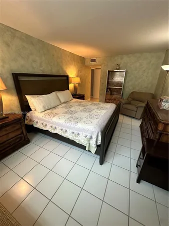 a bedroom with a bed and dresser