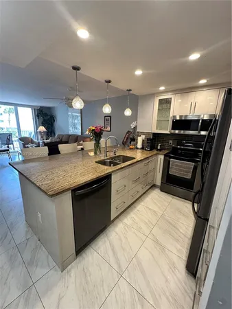 a kitchen with granite countertop a sink and counter top space
