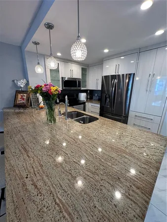 a view of a room with furniture and a chandelier