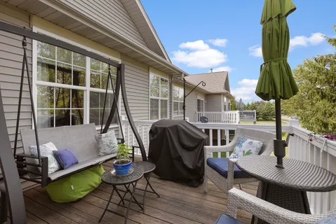 a view of a patio with couches table and chairs and potted plants