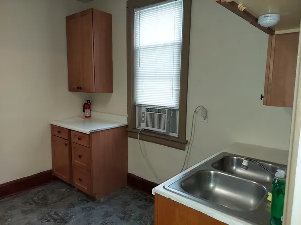 a kitchen with a sink and a mirror