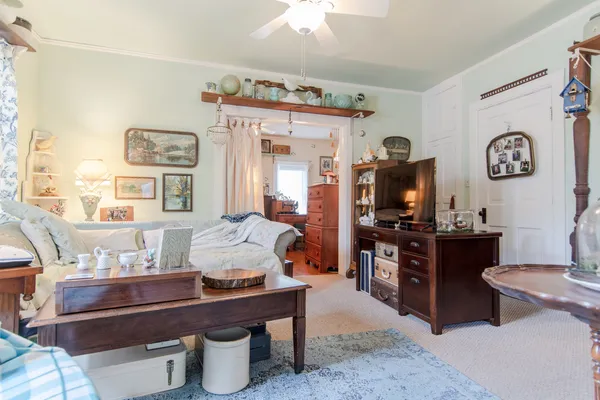 a living room with furniture and a flat screen tv