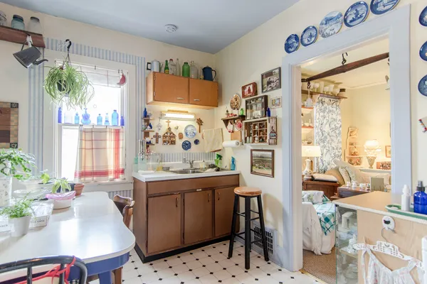 a view of a workspace with furniture and a potted plant